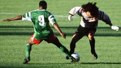 Cameroon's Roger Milla robs the Colombian goalkeeper Rene Higuita and goes on to score.