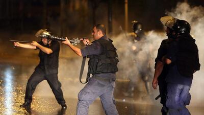 Lebanese security forces fire tear gas canisters towards protesters during clashes. Anwar Amro / AFP