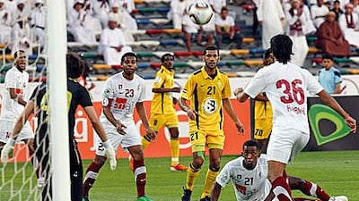 Al Wasl, in yellow, pressurise the Al Wahda goal in last night's Presidents Cup match in Abu Dhabi.