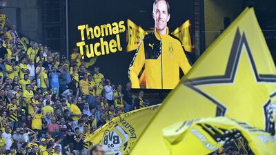 Fans welcome Dortmund's new head coach Thomas Tuchel, on the board, prior the Europa League qualifying soccer match between Borussia Dortmund and Wolfsberger in Dortmund, Germany on Thursday, August 6. Dortmund face Schalke for Tuchel's first taste of the Ruhr valley derby on Saturday, November 7. Martin Meissner / AP Photo