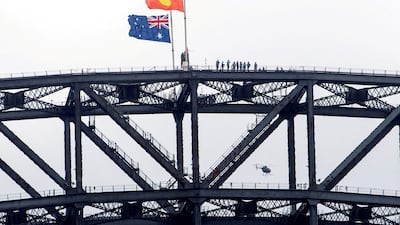 Australia's national flag and the Aboriginal flag flutter at half mast on Sydney Harbour Bridge on a nationwide day of mourning for the victims of the mass shooting at a Jewish event at Bondi Beach last month. Reuters