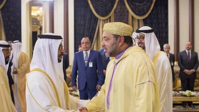 Sheikh Hamdan bin Zayed, the Ruler’s Representative in the Western Region, left, greets King Mohammed VI, centre, during a reception at Mushrif Palace. With them is Sheikh Mohammed bin Zayed, Crown Prince of Abu Dhabi and Deputy Supreme Commander of the Armed Forces, back right. Ryan Carter / Crown Prince Court - Abu Dhabi