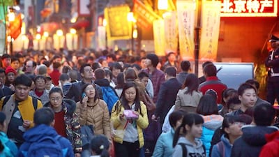 Shoppers walk along a shopping street in Beijing, China. President Xi Jinping signalled China is ready to accept a lower rate of growth, assuring executives that the economy is more resilient than ever and his government can safely guide the country through any slowdown. Tomohiro Ohsumi / Bloomberg