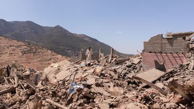 Villagers walk among the rubble near Amizmiz. Bloomberg