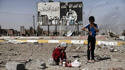 Iraqi children sit amid the rubble in Mosul's Nablus neighbourhood. Arisa Messinis / AFP Photo / MArch 12, 2017