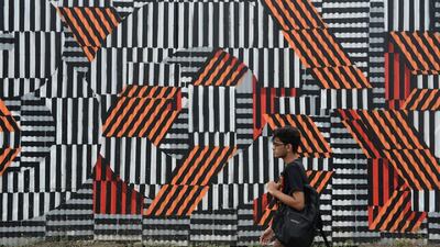 A student walks past graffiti in Mumbai. Indranil Mukherjee / AFP