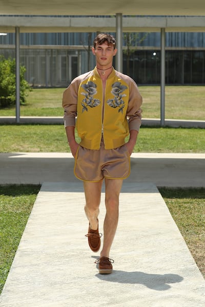 A baseball jacket is softened with flowers, as part of the Etro spring/summer 2023 menswear show. Photo: Etro