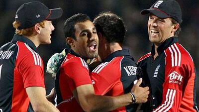 Ravi Bopara is congratulated by Graeme Swann and other England teammates after taking the wicket of Christopher Barnwell of West Indies.