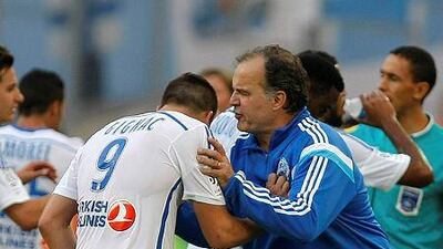 Marseille coach Marcelo Bielsa, right, hugs Marseille forward Andre-Pierre Gignac after his second goal, during their Ligue 1 match against Rennes, at the Velodrome Stadium, in Marseille, southern France, Saturday, Sept. 20, 2014. AP Photo/Claude Paris