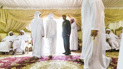 Men gather to pay their respects to the family of Captain Ahmed Khalifa Al Baloushi, 27, a UAE soldier who died in a helicopter crash while serving in Yemen, at a majlis outside the Al Towayya mosque in the Al Towayya area of Al Ain on August 13, 2017. Christopher Pike / The National