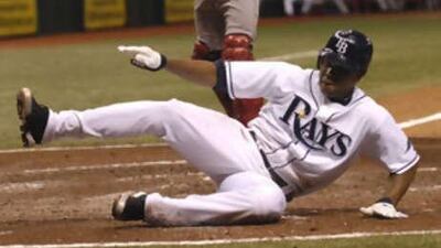 Infielder Willy Aybar of the Tampa Bay Rays slides across home plate and scores against the Boston Red Sox.