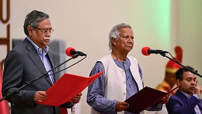 Nobel laureate Muhammad Yunus, centre, takes the oath of office at a ceremony administered by President Mohammed Shahabuddin, left, in Dhaka on Thursday. AFP