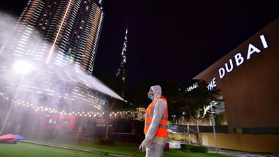 A municipal worker disinfects the streets as a preventive measure against the spread of Covid-19 in downtown Dubai in March 2020. AFP