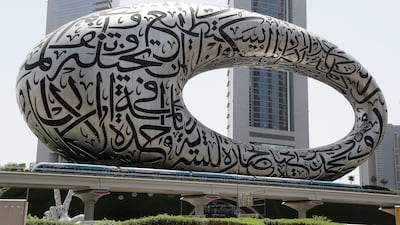 A train passes the Museum of the Future on Sheikh Zayed Road. Pawan Singh / The National