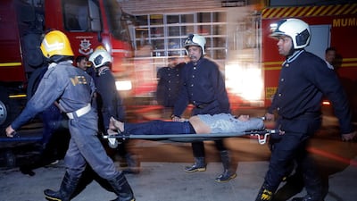 Firefighters carry a victim on a stretcher after a fire at a restaurant in Mumbai, India's financial capital, on December 29, 2017. Reuters