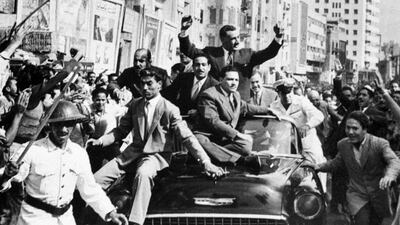 Egypt's late president Gamal Abel Nasser, with raised hands, in a street parade in the 1960s.