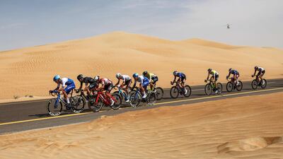 The peloton rides through the desert. AFP