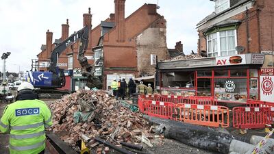 Emergency services at the scene in Leicester where an explosion which killed five people destroyed a building. Aaron Chown/PA via AP