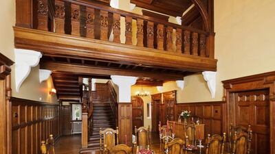 Despite changing hands several times, the house retains architect CJ Cooper’s original carved-oak staircase. Courtesy Cheffins