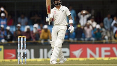 Virat Kohli celebrates after scoring a half century on Day 1. Punit Paranjpe / AFP