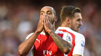 Theo Walcott celebrates after scoring the first goal for Arsenal against Stoke City. Dylan Martinez / Reuters