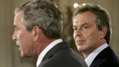 British prime minister Tony Blair looks at US President George W Bush during a joint news conference at the White House in Washington on June 7, 2005. Jason Reed/ Reuters