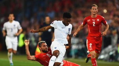 Raheem Sterling of England battles with Valon Behrami of Switzerland during their Euro 2016 qualifier on Monday. Laurence Griffiths / Getty Images / September 8, 2014