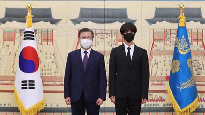 BTS member Jin with the South Korean president. EPA