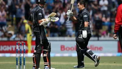 Ross Taylor, right, of New Zealand celebrates his century watched on by teammate Mitchell Santner during the one-day international cricket match between New Zealand and Australia at Seddon Park in Hamilton on February 5, 2017. Michael Bradley / AFP