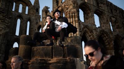 People dressed as vampires gather in the grounds of the gothic ruins of Whitby Abbey, after their Guinness world record attempt, on May 26. AFP