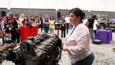Nazli Koseoglu, the general manager of Hammerhead Auto Specialists, explains to the workshop participants the ins and outs of car maintenance at their garage in Al Quoz, Dubai. Pawan Singh / The National