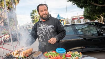 Mokhtar Dhifi, a street vendor in Sidi Bouzid, pictured with his mobile food stall, discusses the revolution of 2011.