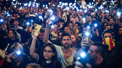 Demonstrators hold up their phones following a week of protests over the jail sentences given to separatist politicians by Spain's Supreme Court. Getty