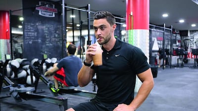 Dan Woolley of Target Fitness, Dubai, drinks a protein shake to restore energy after a workout. Pawan Singh / The National