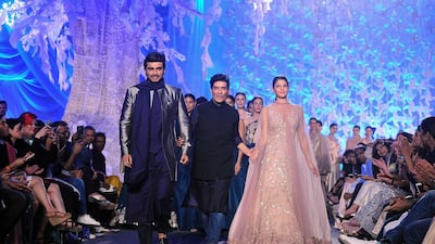Indian Bollywood actors Jacqueline Fernandez and Arjun Kapoor showcase creations by designer Manish Malhotra. AFP