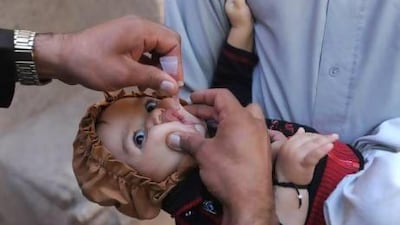 An Afghan child receives a polio vaccination in Herat last year. Plans are in place to eradicate the disease by 2018. Aref Karimi / AFP