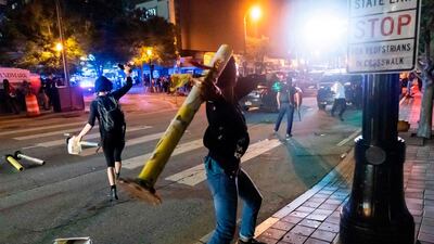 Protesters face off with police during rioting and protests in Atlanta. AFP