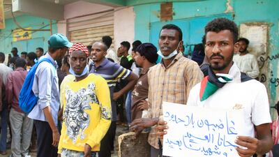 A Sudanese protester carries a placard which reads: 'Angry without borders, Eid is here and the martyr is absent' as he takes part in a rally in southern Khartoum. AFP