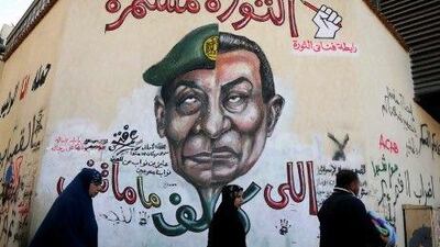 Some Egyptians have blamed the country's instability on the Supreme Council of the Armed Forces overseeing the transition to democracy, as depicted in this Cairo graffiti with the military's leader Field Marshal Mohammed Hussein Tantawi's face, left, set next to the caricature of the former president Hosni Mubarak, right.