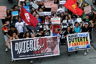Protesters march during a rally calling for the imprisonment of Mr Duterte in Manila, Philippines. EPA