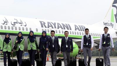 Rayani Air cabin crew in front of a Boeing 737-400 at Kuala Lumpur International Airport. EPA