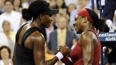 Serena Williams, right, embraces her sister Venus after defeating her in their US Open quarter-final match.