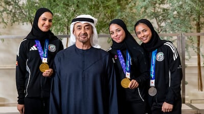 UAE President Sheikh Mohamed attends a reception for members of the country's jiu-jitsu team who won medals at the Asian Games in Japan. Ryan Carter / UAE Presidential Court