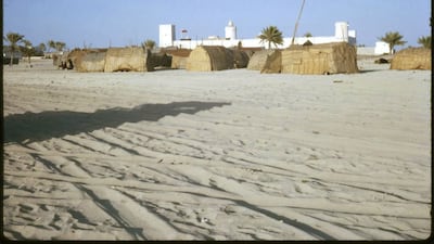 Qasr Al Hosn with traditional barasti homes in the foreground. Photo: David Riley / UAE National Library and Archives