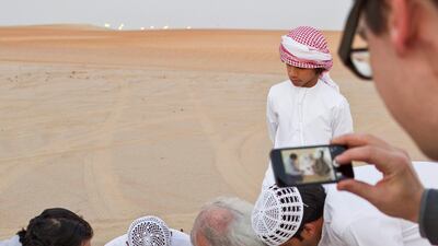 Christo meets with Liwa residents Khalfan Al Qubasi, left, and Saeed Al Falahi, right. Antonie Robertson / The National