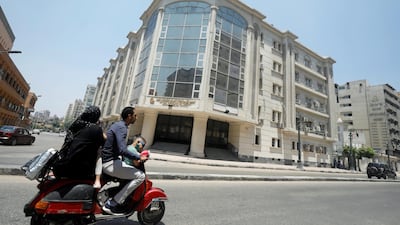A family rides a motorbike in front of National Hepatology and Tropical Medicine Research Institute amid concerns about the spread of the coronavirus disease (Covid-19), in Cairo, in Egypt May 26, 2020. Reuters