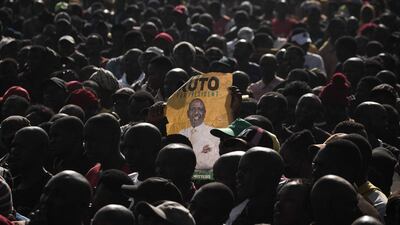A supporter holds a poster of Kenya's Deputy President William Ruto during his first rally after being officially nominated as a presidential candidate in Nairobi. AFP