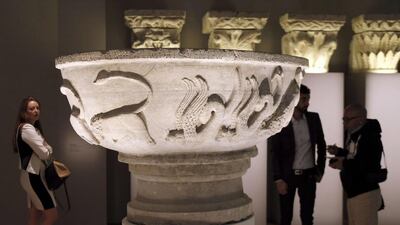 People looking at a ‘Bonifilius’ bassin made in northern Italy in the 12th century. Francois Guillot/AFP