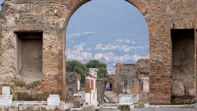 A view of the Pompeii site through an archway.
