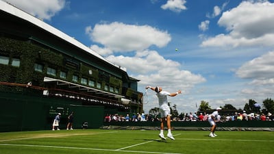 General view of Court 5 as Gilles Muller of Luxembourg serves during his doubles match with Jamie Delgado against Yen-Hsun Lu and Divij Sharan on Wednesday at Wimbledon 2014. Muller and Delgado won in five sets. Al Bello / Getty Images